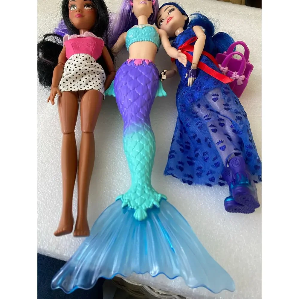 three dolls Barbie Dreamtopia Mermaid Doll with purple hair and purple-and blue